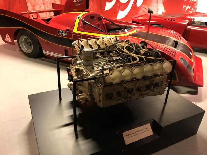 Alfa flat 12 F1 engine, hnnnngh. Behind it a 1976 Tipo 33/SC/12 (SC= monocoque, 12 = cylinders). Alfa won the World Sportscar Championship in 75 and 77 with flat 12 Tipo 33s (but not 76, the year of this car). Love that rear vision mirror. Hear it in action here (the good stuff starts at 1:40)